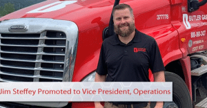 Bearded man in a black polo stands beside a red truck; banner across bottom reads 'Jim Steffey Promoted to Vice President, Operations'.