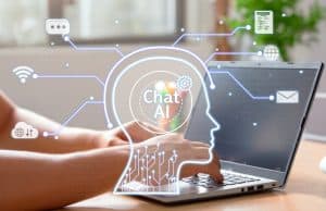 Person typing on a laptop with glowing holographic AI chat icons and network lines surrounding the screen.