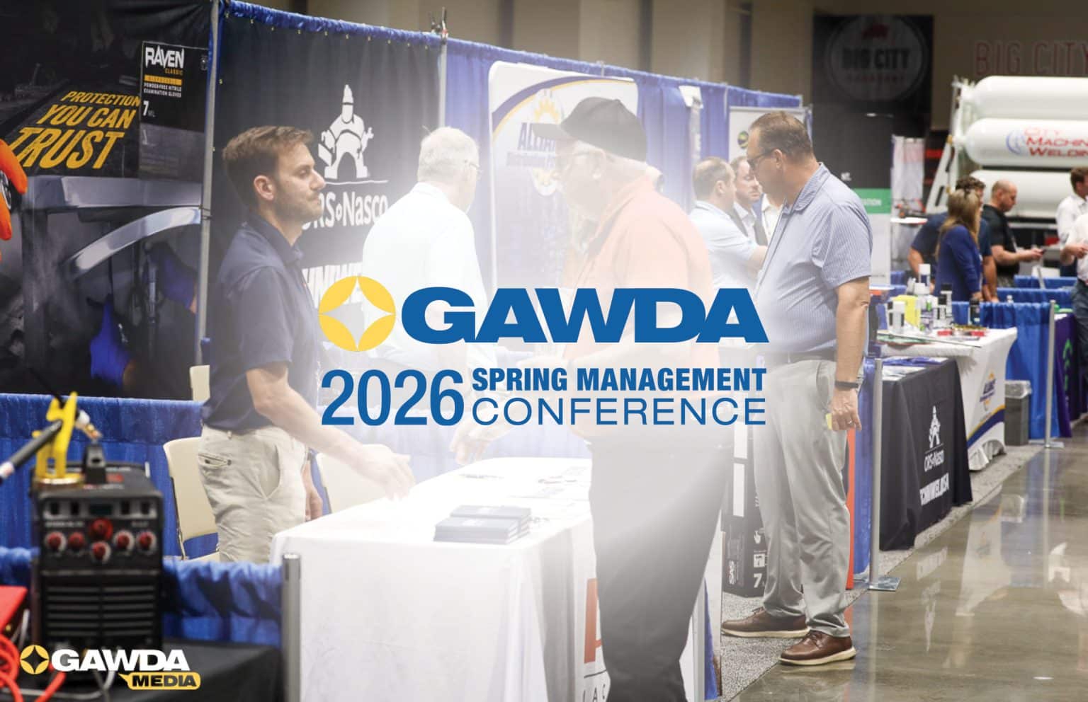 Exhibition hall at a conference with GAWDA branding and attendees talking at booth tables with blue dividers.